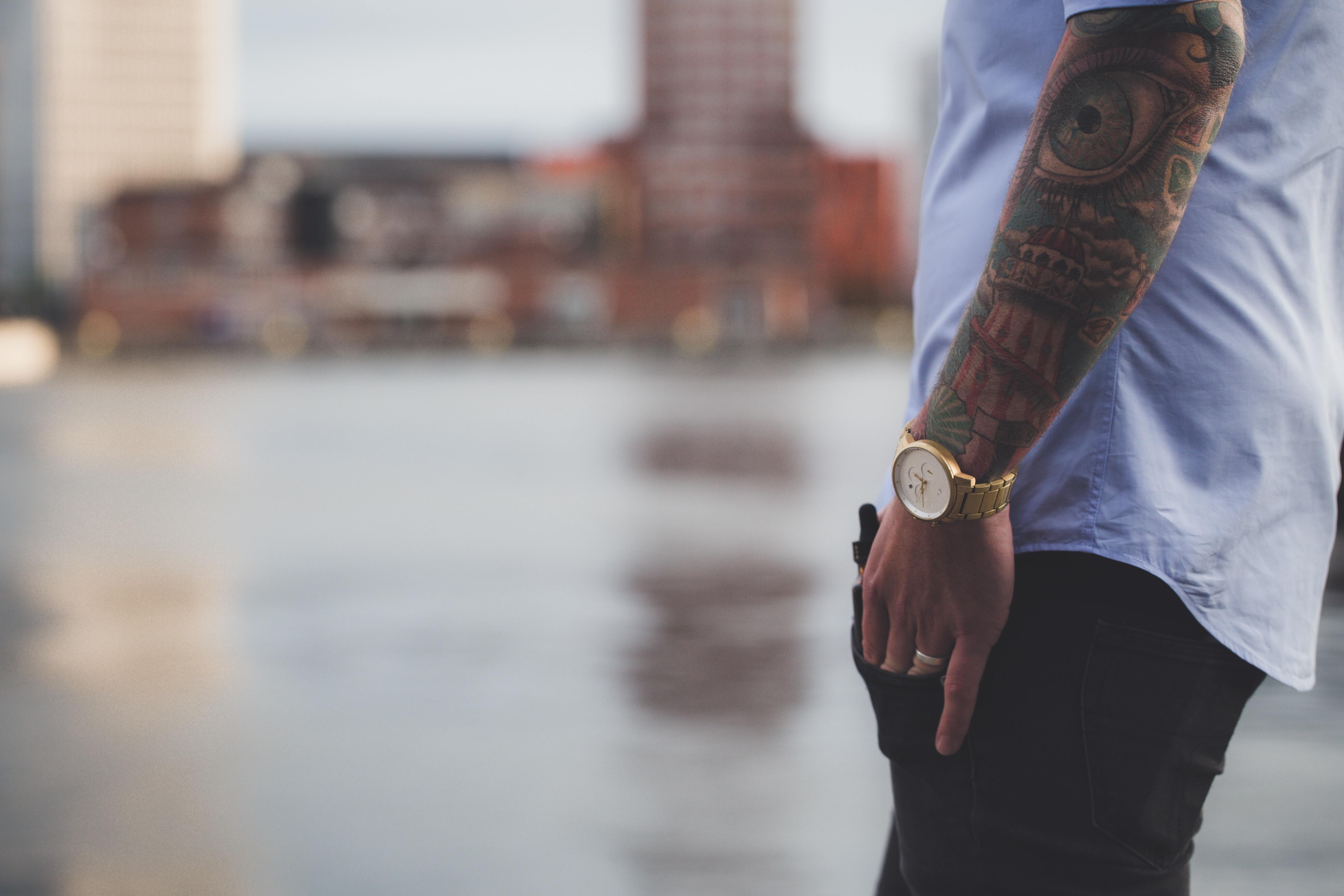 man with tattoos in a shirt